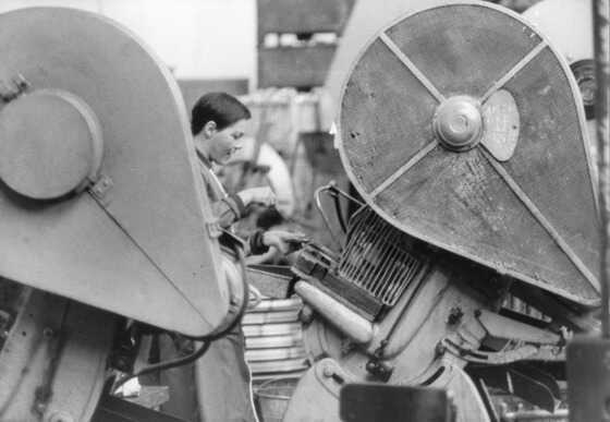 Ouvrière sur une presse de l'usine Guillouard
